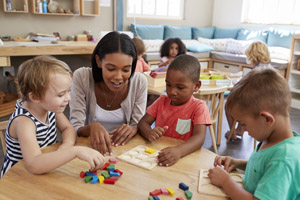 A caregiver teaching kids in a daycare