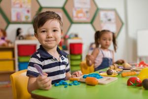 Two children playing in a daycare with blocks