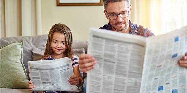Dad and daughter reading the news