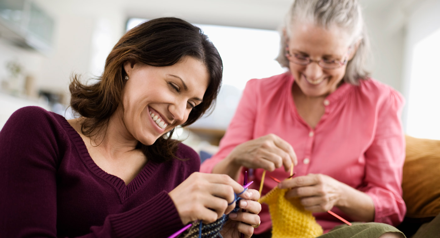  a young lady knitting with a older lady