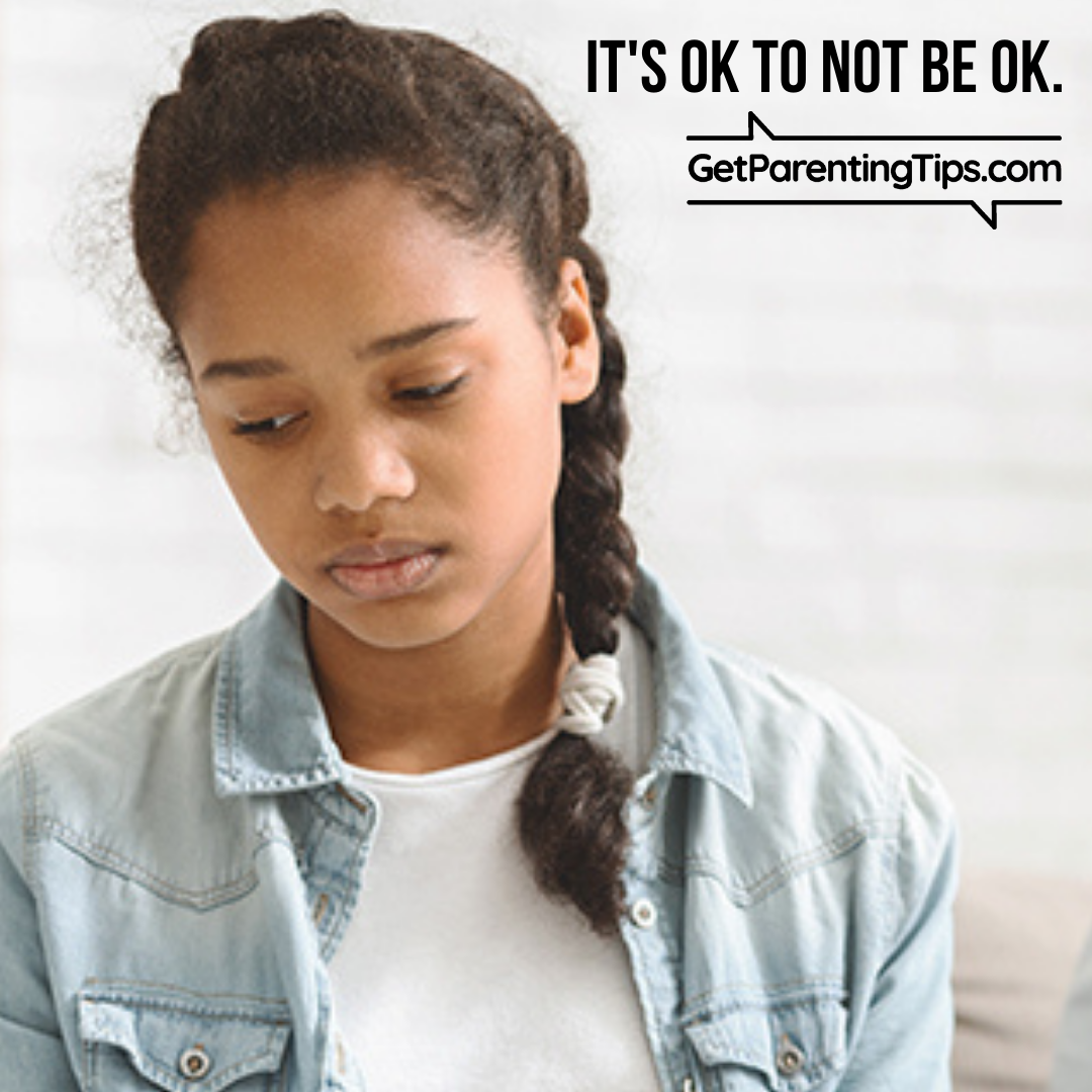 Teenager looking down sadly. Text: It's OK to not be OK. GetParentingTips.com