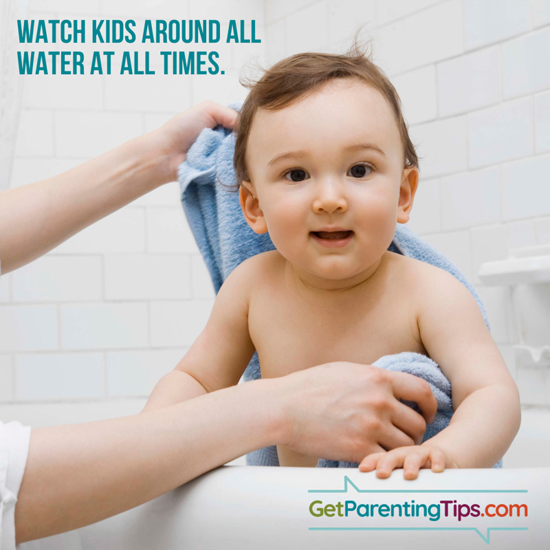 Adult drying off a toddler in a bathtub. Watch Kids around water at all times! GetParentingTips.com