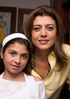 Caregiver and child smiling and looking at the camera.