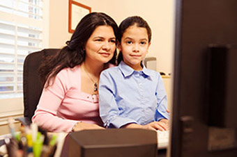 Lady and child looking at the computer.