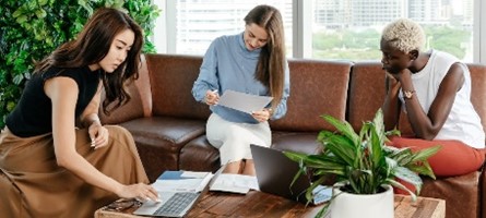 Group sitting at table looking over documents