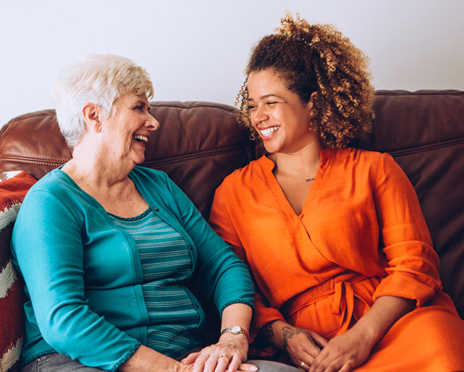 A volunteer and an elderly lady sitting and enjoying each other's company.